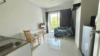 Bright living room with balcony and modern furnishings in a cozy apartment.