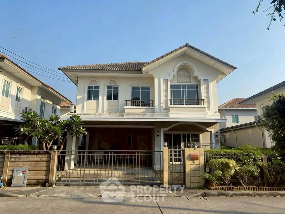 Charming two-story house with elegant facade and spacious driveway in a serene neighborhood.