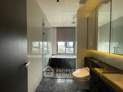 Luxurious modern bathroom with city view, featuring sleek fixtures and elegant marble finishes.
