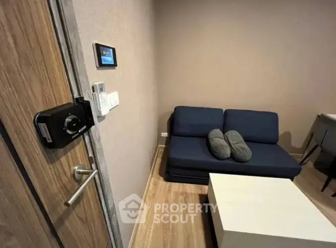 Modern living room with smart lock and cozy sofa in stylish apartment.