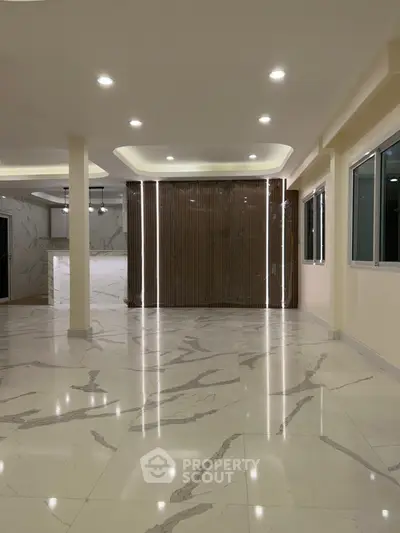 Spacious modern living room with marble flooring and elegant lighting