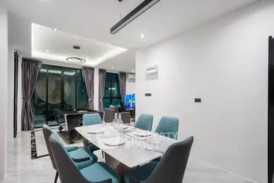 Luxurious dining area with modern decor and pool table in open living space