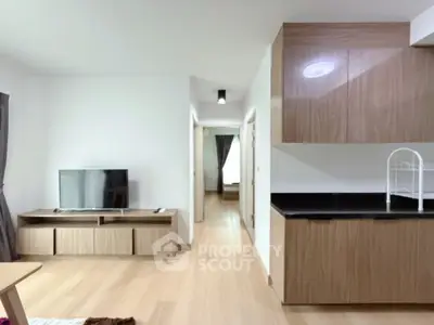 Modern living room with sleek wooden furniture and TV setup