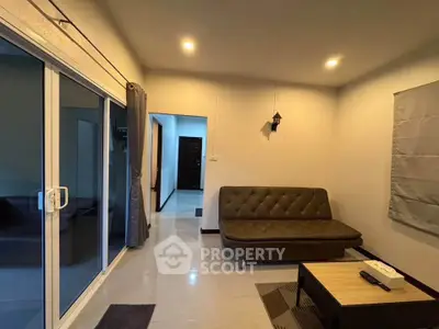 Modern living room with sliding glass doors and stylish sofa, perfect for relaxation and entertaining.