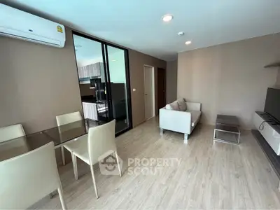 Modern living room with open layout and sleek furniture in a stylish apartment.
