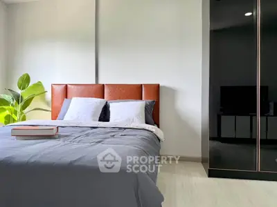 Modern bedroom with stylish bed and sleek wardrobe