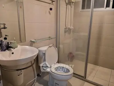 Modern bathroom with glass shower enclosure and sleek fixtures