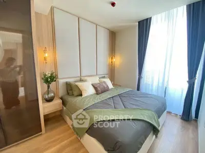 Modern bedroom with stylish decor and large window for natural light