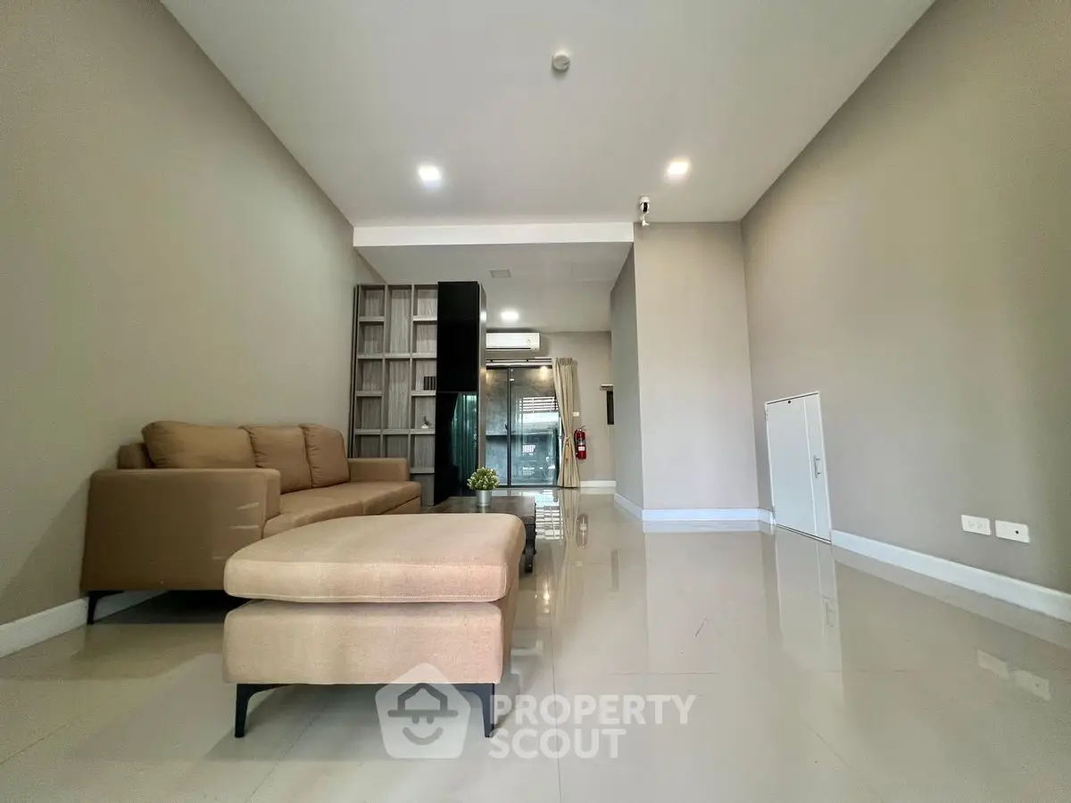 Spacious modern living room with sleek furniture and glossy floors