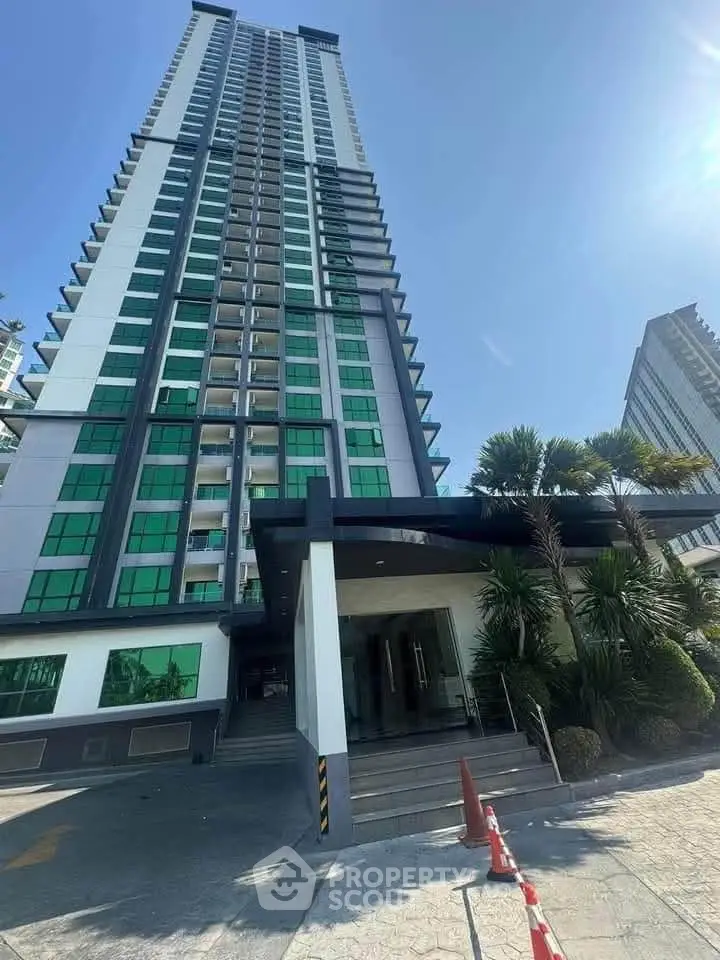 Stunning modern high-rise building with sleek architecture and lush landscaping.
