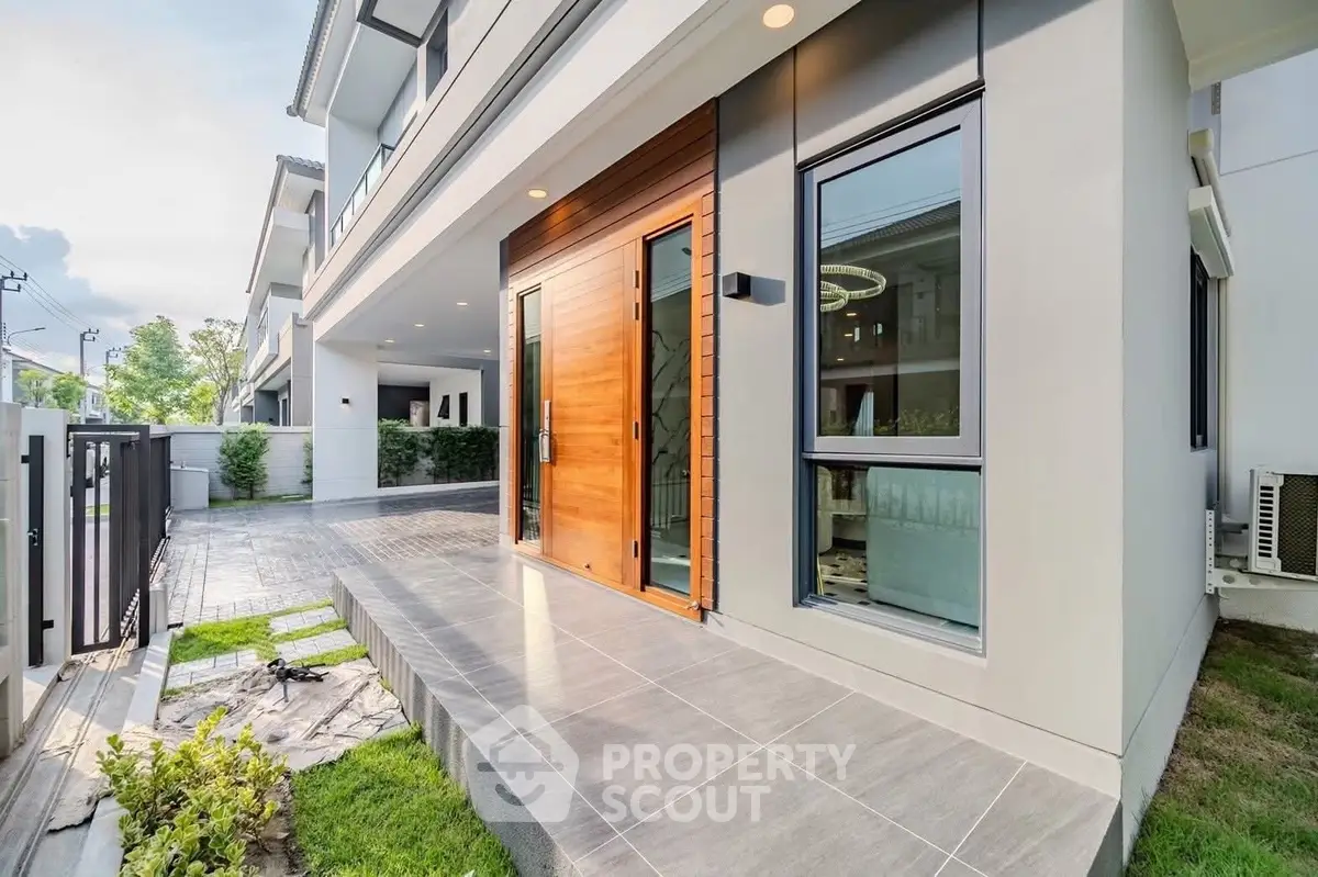 Modern house entrance with sleek design and spacious patio
