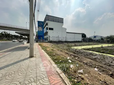 Prime real estate land for development near main road with potential for commercial or residential projects.