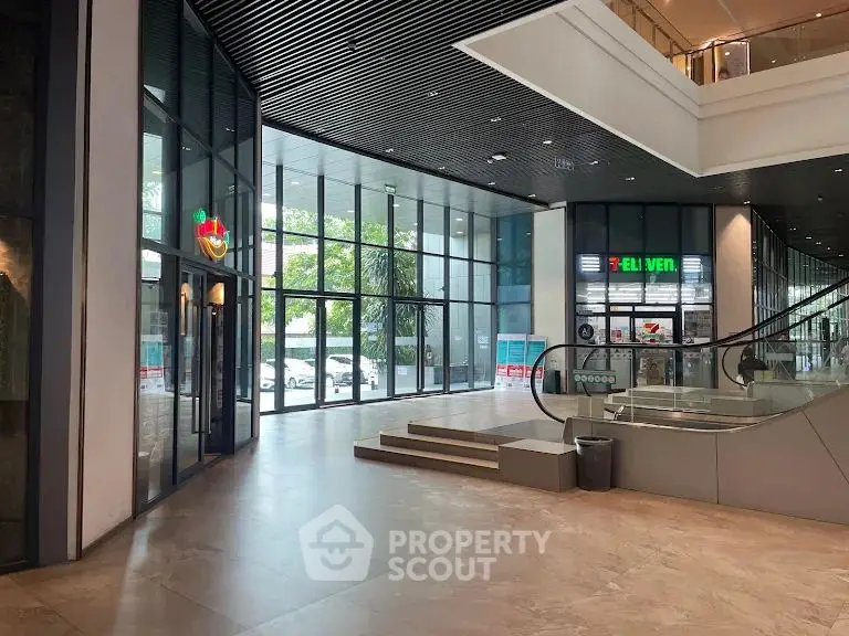 Modern commercial building entrance with escalator and glass facade