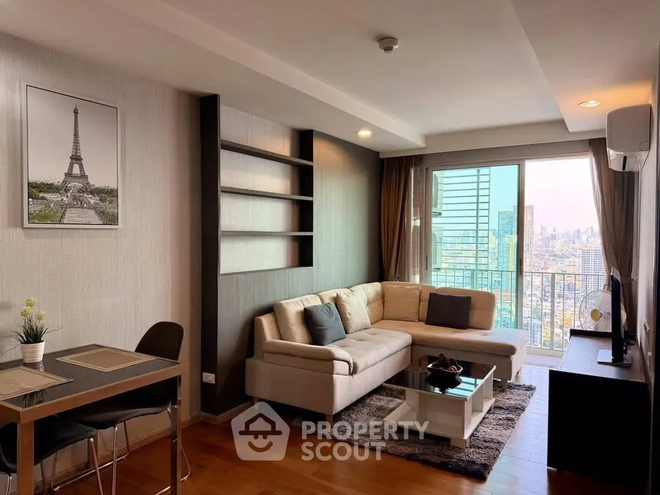 Modern living room with city view, elegant decor, and cozy seating area in a high-rise apartment.