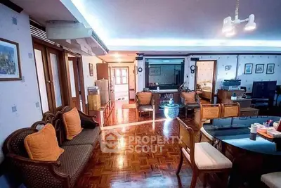 Spacious living room with elegant wooden flooring and cozy seating area.