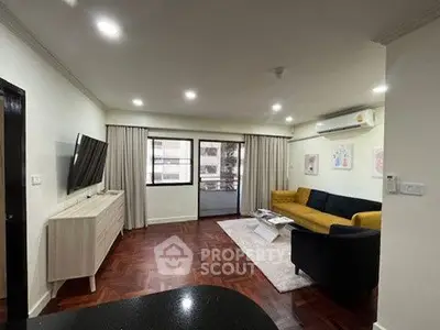 Spacious living room with modern decor and large windows in a stylish apartment.