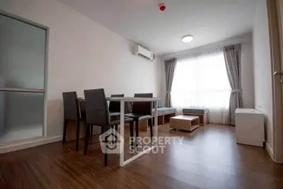 Modern living room with sleek furniture and large window, perfect for natural light lovers.