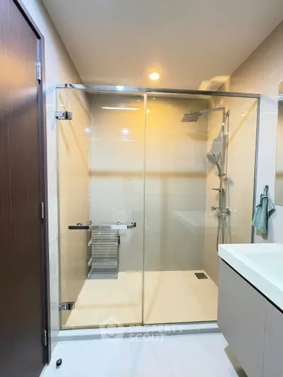 Modern bathroom with glass shower enclosure and sleek fixtures