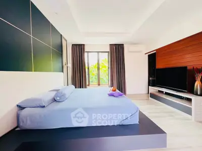 Spacious modern bedroom with large bed and stylish decor