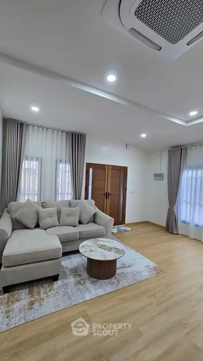 Spacious living room with modern decor and natural light