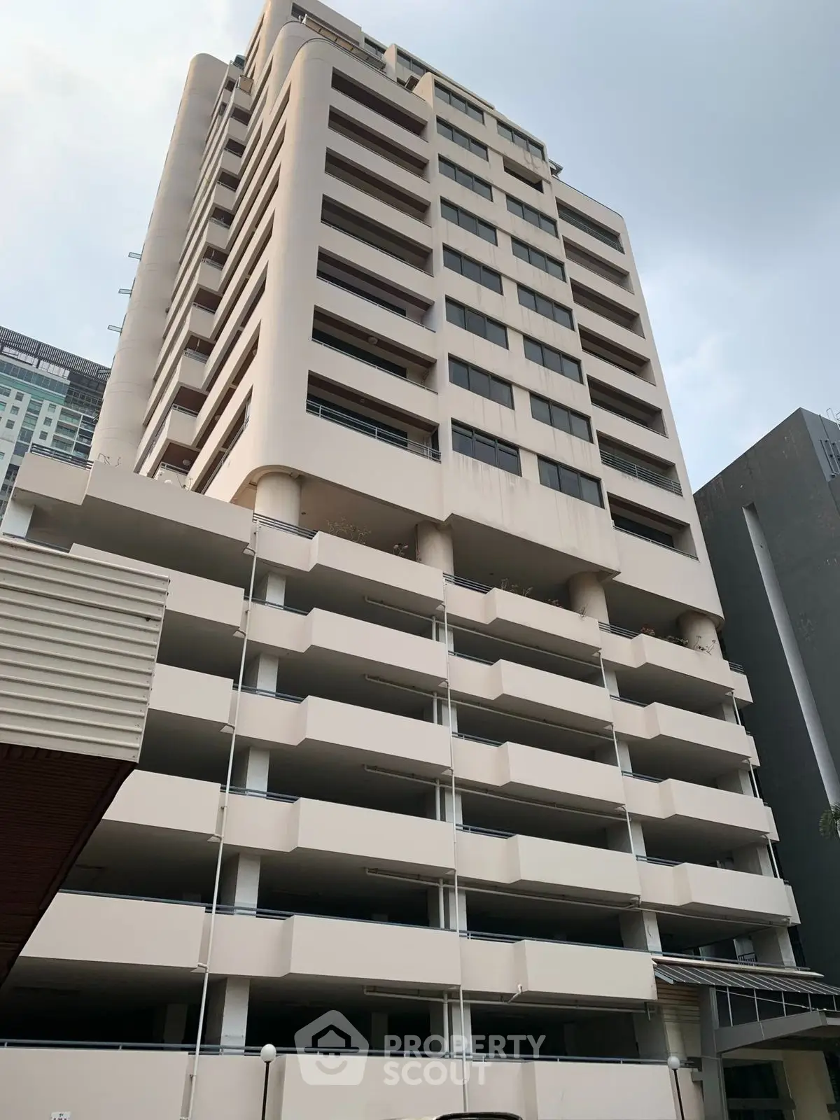 Modern high-rise building with multiple balconies in urban setting