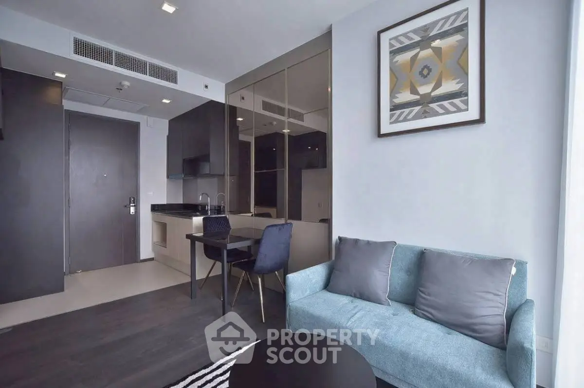Modern living room with sleek design, featuring a cozy sofa and stylish dining area.