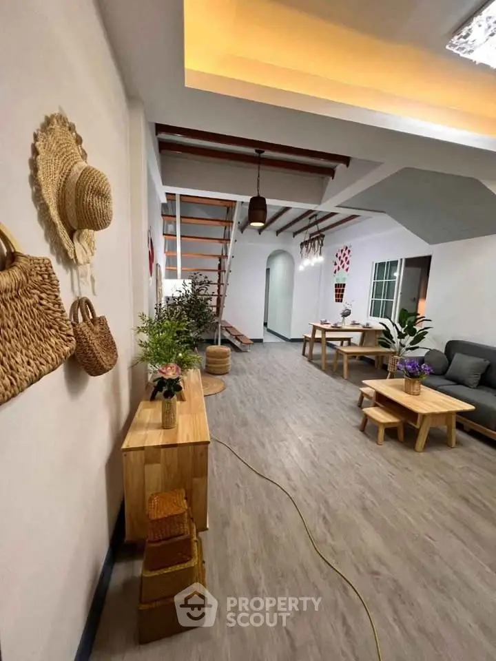 Spacious modern living room with stylish decor and wooden furniture, featuring a cozy seating area and elegant lighting.