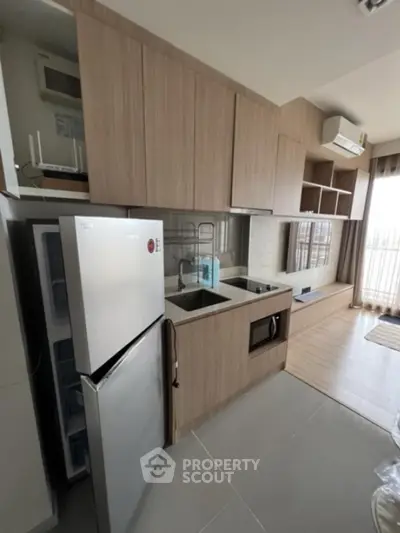 Modern kitchen with sleek cabinetry and built-in appliances in a stylish apartment.