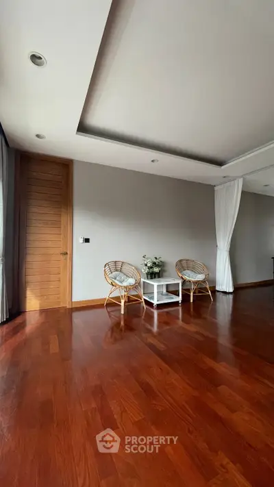Spacious living room with wooden flooring and elegant decor