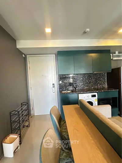 Modern kitchen with sleek cabinets and integrated washing machine in stylish apartment