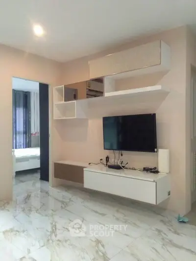 Modern living room with sleek TV unit and marble flooring