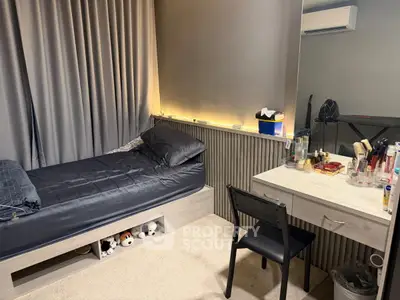 Cozy bedroom with modern decor, featuring a sleek bed and stylish vanity area.