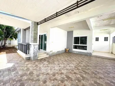Spacious outdoor patio with modern design and tiled flooring, perfect for entertaining guests.