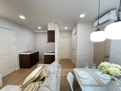 Modern open-plan living room and kitchen with stylish decor and dining area.