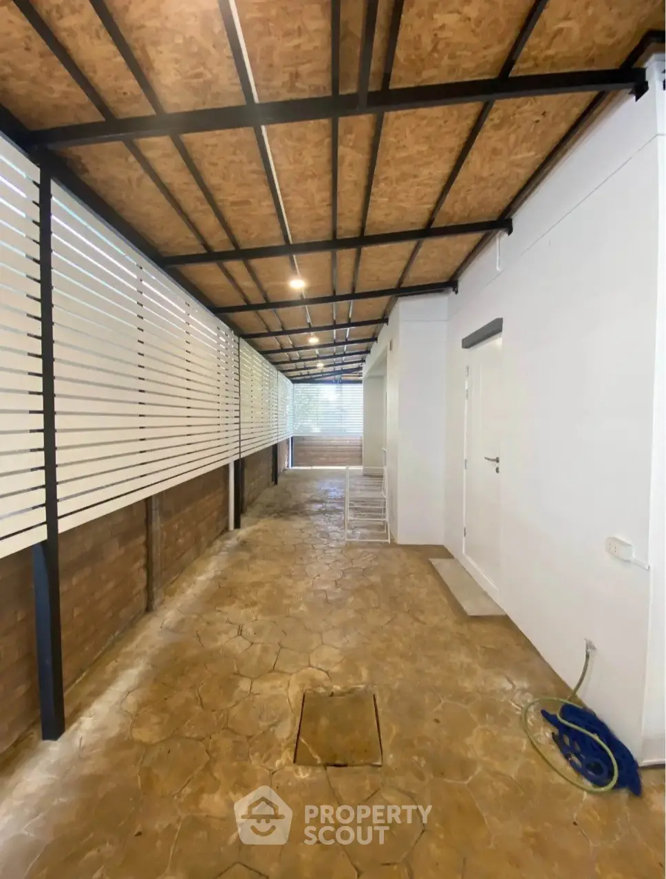 Spacious covered outdoor area with modern design and ample natural light.