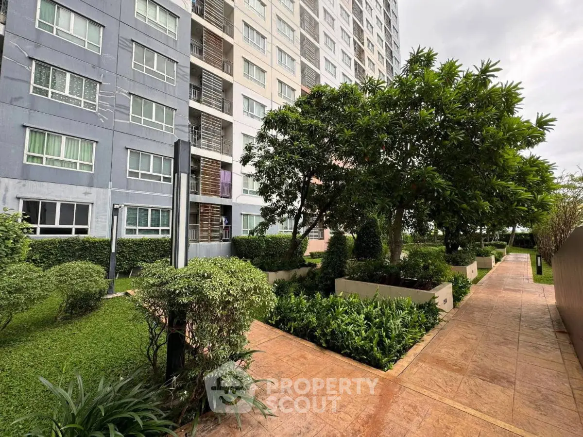 Modern apartment building with lush garden and walkway