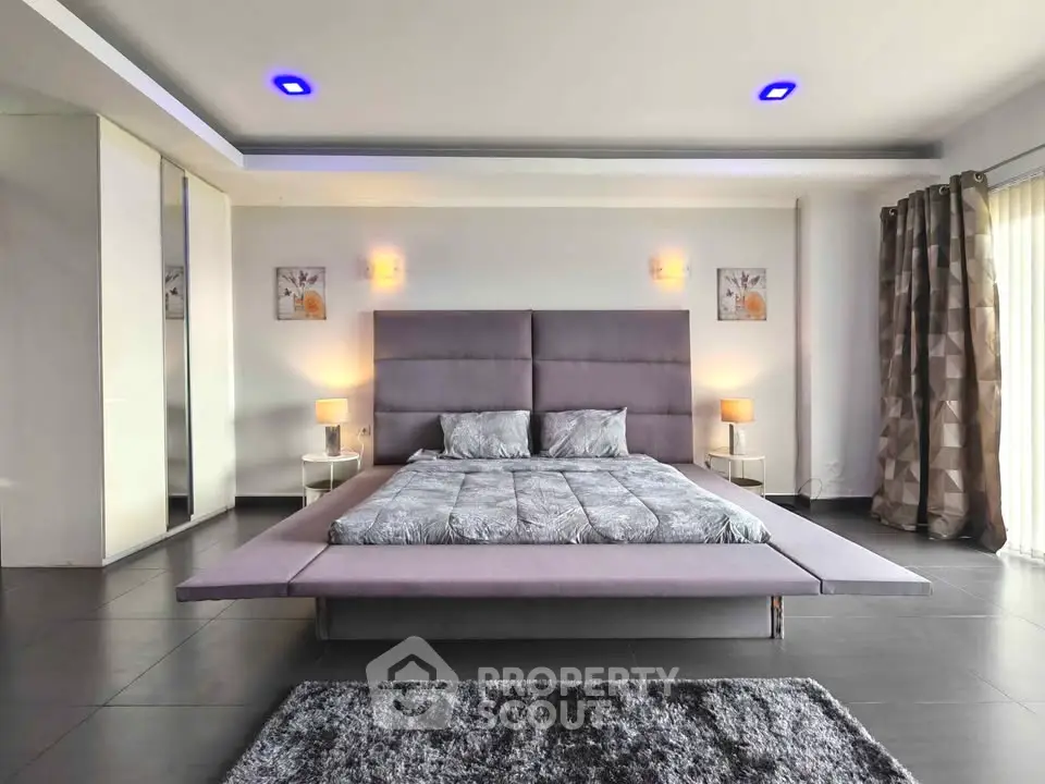 Luxurious modern bedroom with stylish decor and ambient lighting