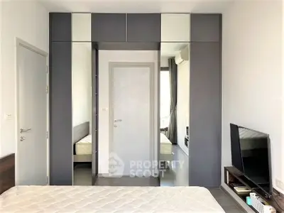 Modern bedroom with sleek built-in wardrobe and minimalist decor