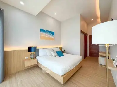 Modern bedroom with stylish decor and natural lighting, featuring a cozy bed and elegant furnishings.