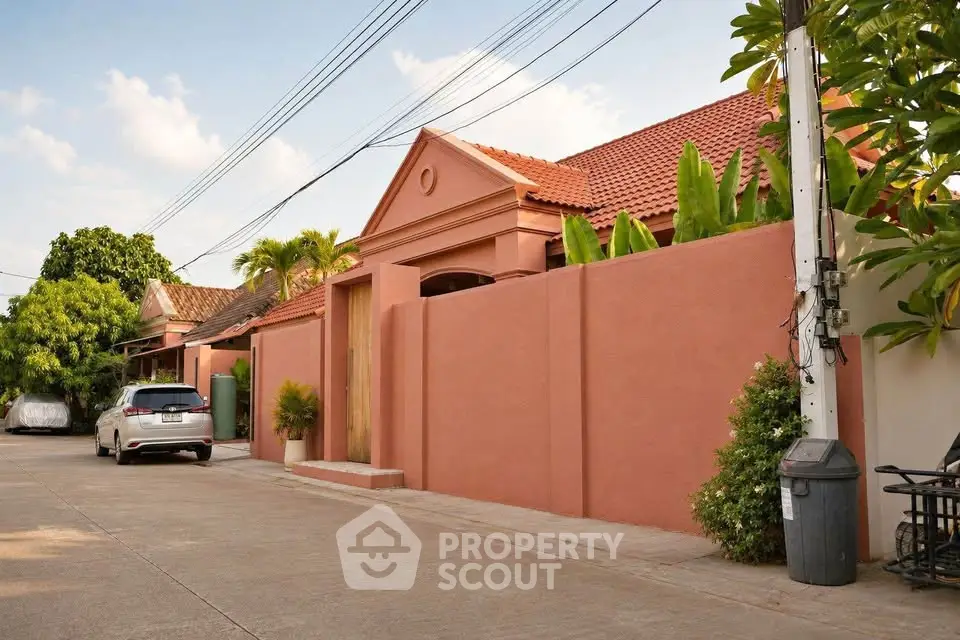 Charming suburban house with terracotta roof and lush greenery, perfect for family living.