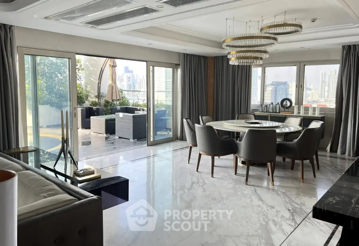 Luxurious living room with marble floors, elegant dining area, and stunning city view from large balcony.