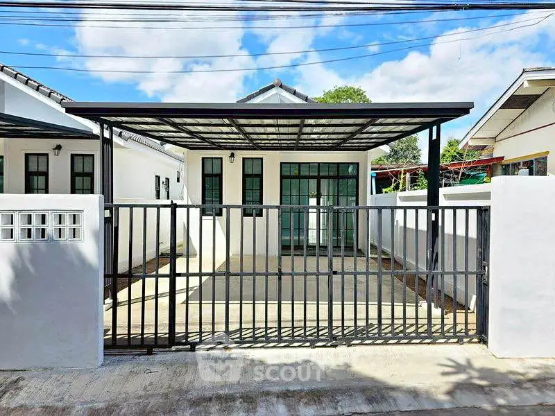 Charming single-story home with modern gated entrance and spacious driveway.