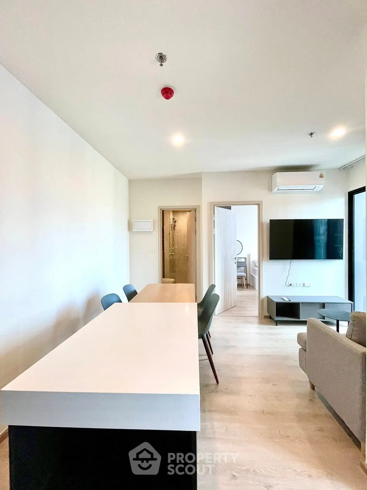 Modern open-plan living room with sleek furniture and natural light.