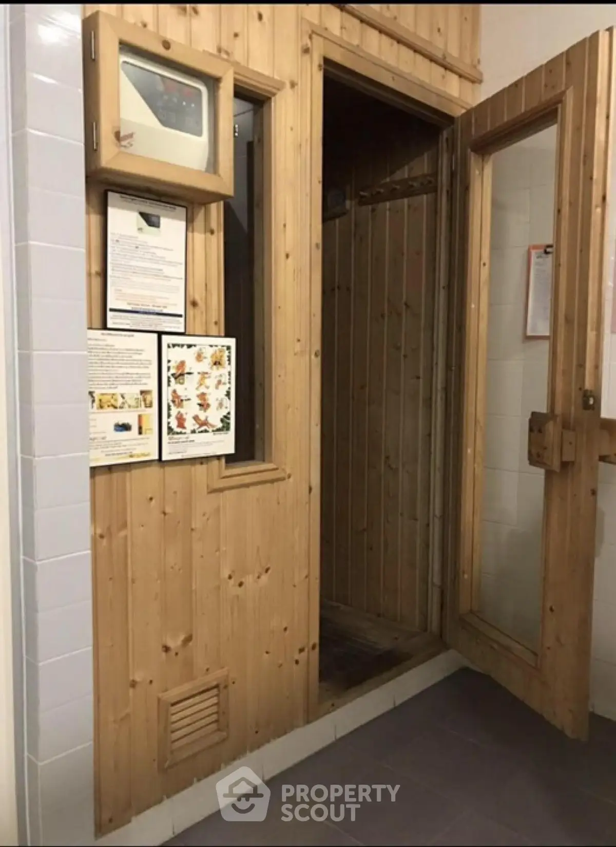 Cozy wooden sauna room with glass door in modern building