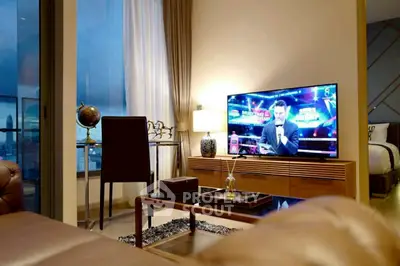Modern living room with TV, stylish furniture, and city view, perfect for urban lifestyle.