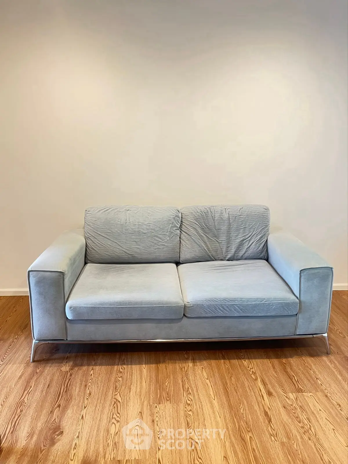 Modern living room with stylish blue sofa on wooden floor