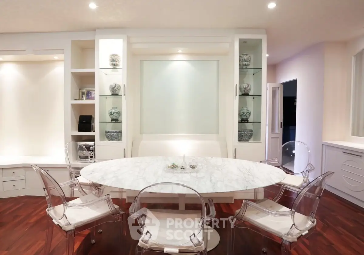Elegant dining area with marble table and transparent chairs in modern home