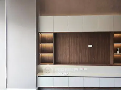Modern minimalist living room with built-in wooden shelving and sleek cabinetry
