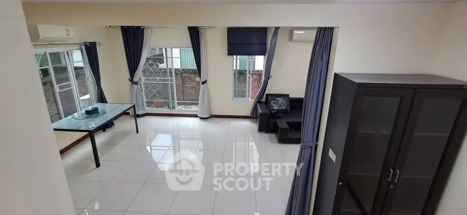 Spacious living room with large windows and modern furniture