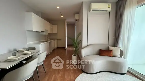 Modern open-plan living room with sleek kitchen and stylish furniture, perfect for contemporary living.